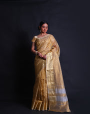 The gold-crusted tissue saree with a gold zari border and pallu exudes luxury and opulence.- FCT011106