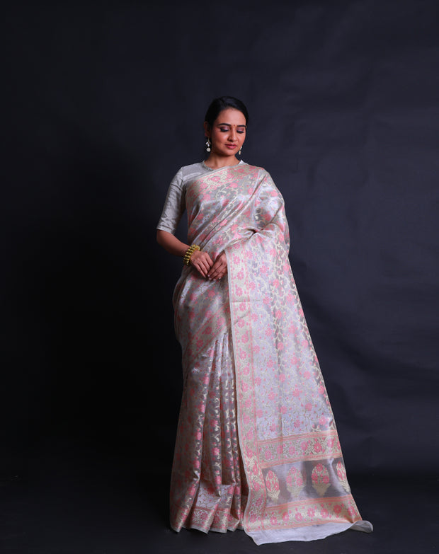 The beige tissue cotton saree with zari and pink thread woven in flower design all over the drape sounds elegant and refined,- FCT011109