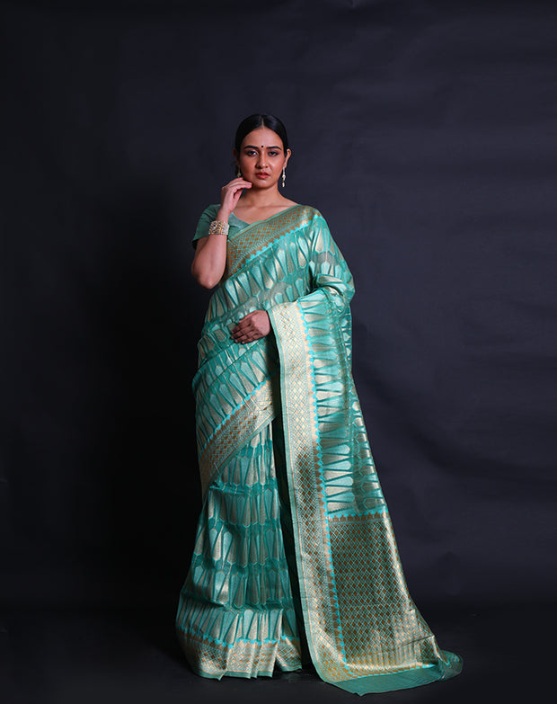 A green blended saree features beige thread buttis scattered elegantly across the drape, - BLN01078