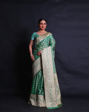 A green blended saree features beige thread buttis scattered elegantly across the drape,- BLN01076