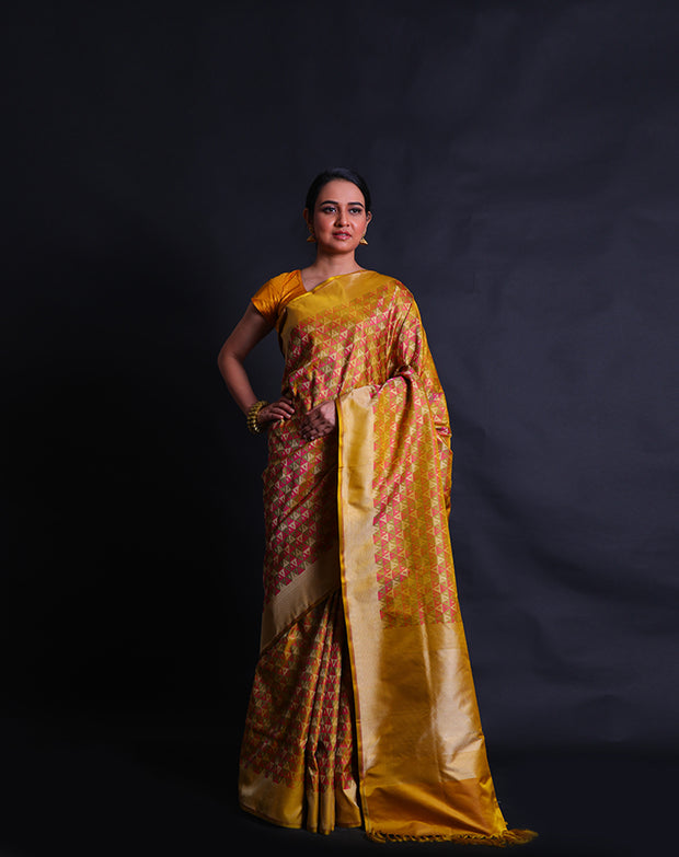 The green Banarasi silk saree with multi-colored woven design all over the drape.- BSK010580