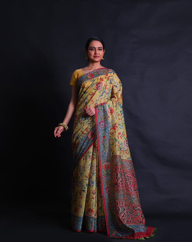The mustard blended cotton saree with a colorful flower design printed in digital all over the drape sounds vibrant and charming,- BLN01345