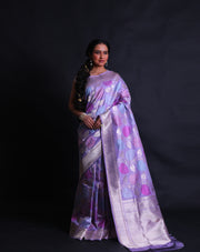 The light mauve Banarsi silk saree exudes elegance with its intricate leafy design woven delicately in zari and thread,- BSK010512