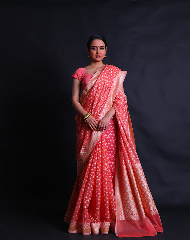 The peach kora cotton saree with zari and thread woven in different designs.- BSK010448