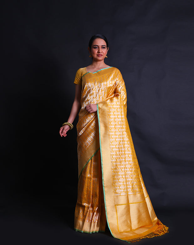 The mustard Banarasi silk saree with gold and silver buttis in a geometrical design,- BSK010514