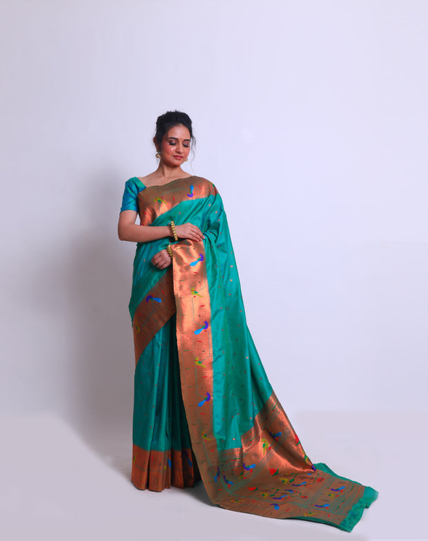 The peacock blue blended saree with Pathani parrot and raindrops zari design on the border and pallu sounds absolutely mesmerizing - BLN01289