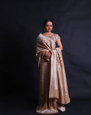 The beige Banarasi linen Khadi georgette saree adorned with silver zari buttis all over the drape,- CHG04026