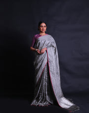 The dark grey Banarasi silk saree you're describing features a modern zig-zag design throughout,- BSK010541