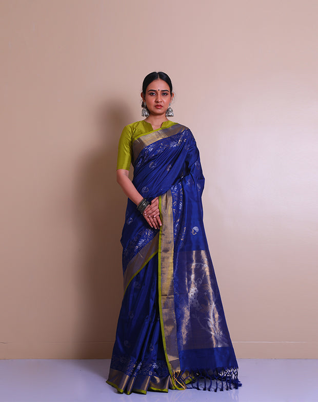 A peacock blue Uppada real zari saree is adorned with small buttis of silver and gold zari scattered throughout the drape, - OPD01736