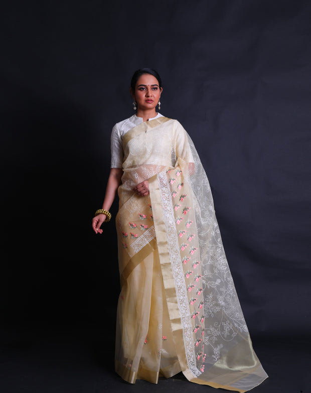 The light yellow organza saree with machine embroidery in white flower design all over the drape,- BLN01555