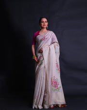 The beige blended Tussar cotton saree adorned with machine-embroidered flower designs in wine, green thread, - BLN01373