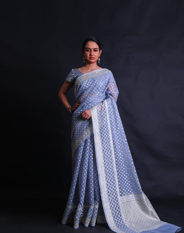 The light blue kora cotton saree adorned with zari and thread woven small buttis all over the drape,- BSK010448
