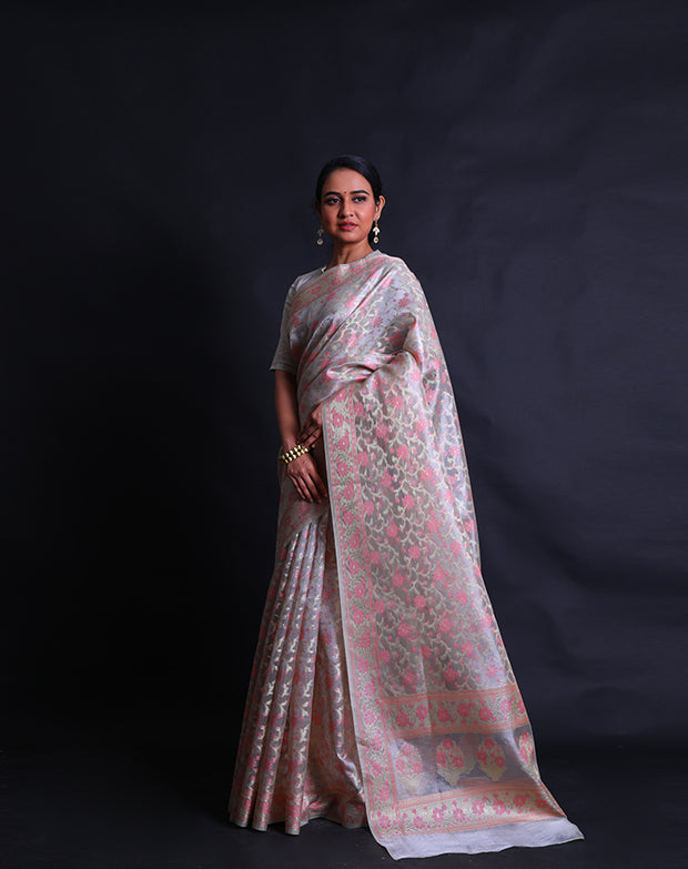 The beige tissue cotton saree with zari and pink thread woven in flower design all over the drape sounds elegant and refined,- FCT011109