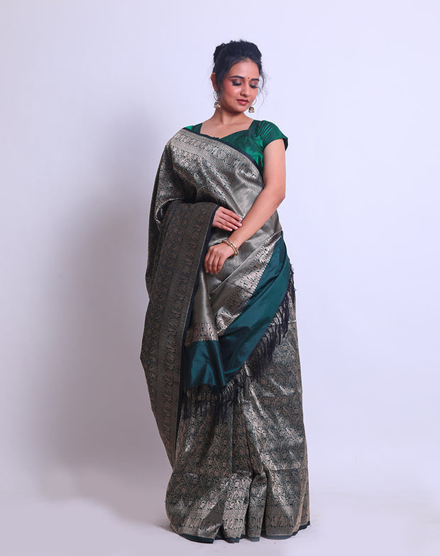 A Dark Bottle Green Handloom Silk saree with different Shikara designs in the border - BSK010299