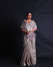 The grey kora saree adorned with thread and zari woven in Anand designs all over the drape,- BSK010529