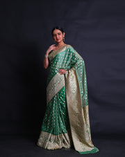 A green blended saree features beige thread buttis scattered elegantly across the drape,- BLN01076