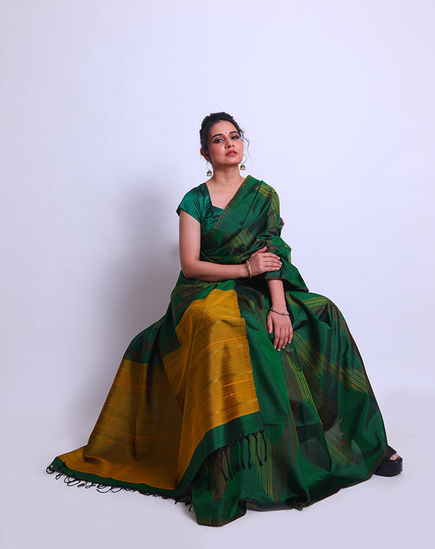 A Bottle Green South Soft Silk saree with a combination of red and yellow lines woven as a design on the border and all over the drape sounds captivating - KSL03091