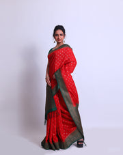 A Red Soft Silk saree with a contrast green border and pallu adorned with antique Zari - FCT011141