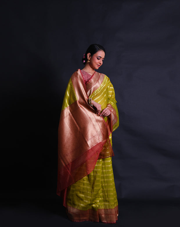 The green Banarasi cotton saree with zari horizontal lines all over the drape sounds elegant and refined.- BSK010641