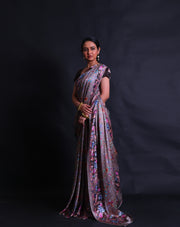 The grey satin silk saree is a vision of elegance, adorned with digital prints in satin embroidery design style that gracefully envelop the entire drape.- CRP00986