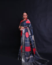 The black Desi Tussar saree featuring a zari border and pallu exudes timeless elegance.- PTS05292
