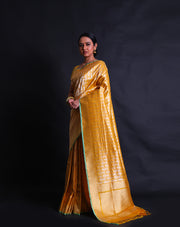 The mustard Banarasi silk saree with gold and silver buttis in a geometrical design,- BSK010514