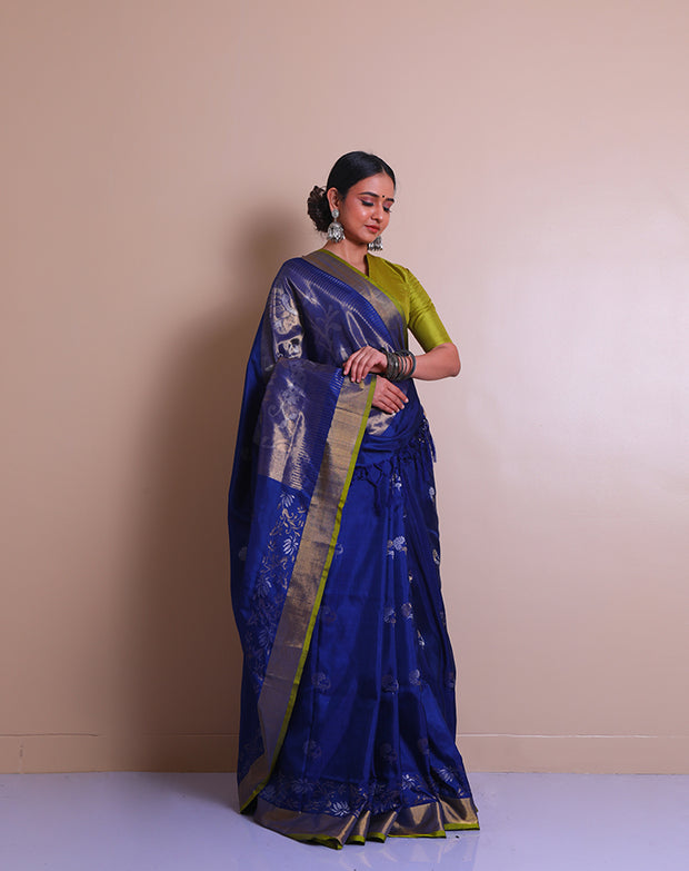 A peacock blue Uppada real zari saree is adorned with small buttis of silver and gold zari scattered throughout the drape, - OPD01736