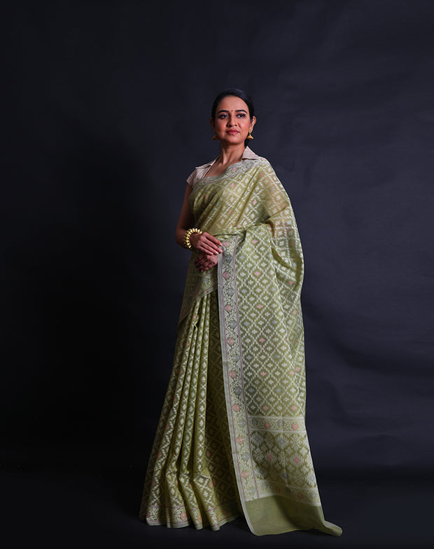 The light green cotton saree with different colored threads woven into designs as buttis.- FCT011114