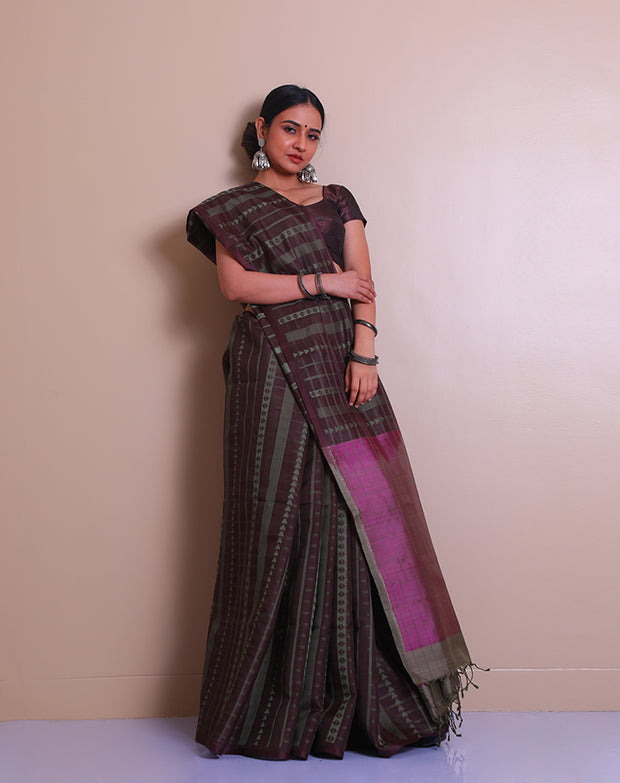 The brown soft silk saree with green thread woven in a geometrical design all over the drape - KSL03125