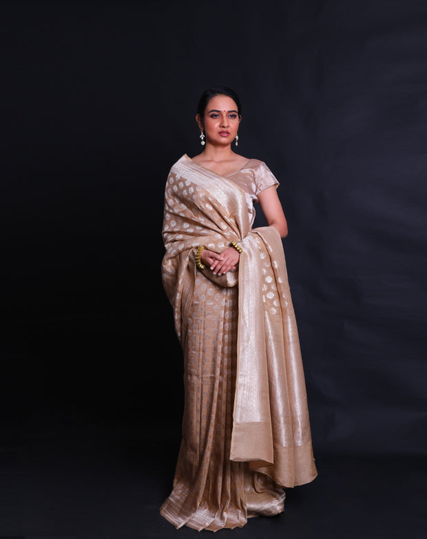 The beige Banarasi linen Khadi georgette saree adorned with silver zari buttis all over the drape,- CHG04026