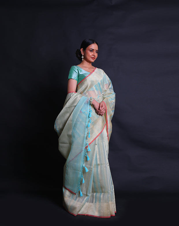 A fancy cotton light blue saree features zari lines woven all over the drape, - FCT011113