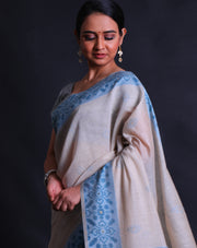 The Beige blended Tussar cotton saree with small buttis of zari and blue thread all over the drape,-  BLN01371