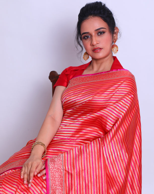 A Red Silk Handloom Saree with a combination of Zari and contrast colors woven in stripes all over the drape sounds captivating - BSK01054