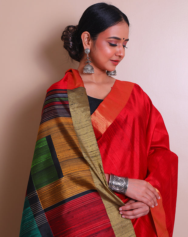 The red raw silk saree with a gold zari border, paired with a contrast black pallu - KSL02734