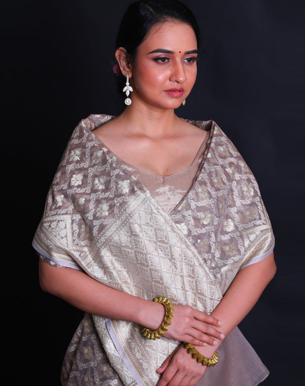 The grey kora saree adorned with thread and zari woven in Anand designs all over the drape,- BSK010529
