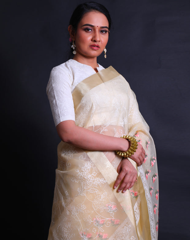 The light yellow organza saree with machine embroidery in white flower design all over the drape,- BLN01555