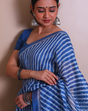 The blue blended saree with a modern print and a thin solid border sounds contemporary and chic. - BLN00932