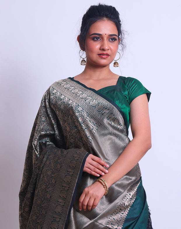 A Dark Bottle Green Handloom Silk saree with different Shikara designs in the border - BSK010299