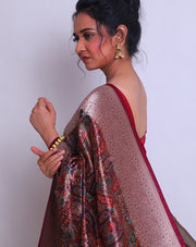 The brown blended saree with a parsley design all over the drape, accented by silver zari buttis and a rust selvage - BLN01139