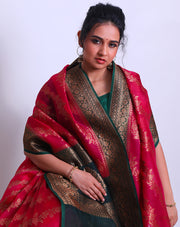 A Rani Pink organza Handloom saree with a contrast bottle green border and pallu featuring antique Zari sounds stunning - BSK010617