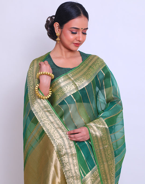 The green organza saree with zari vertical lines woven all over the drape sounds elegant and sophisticated - BSK010624