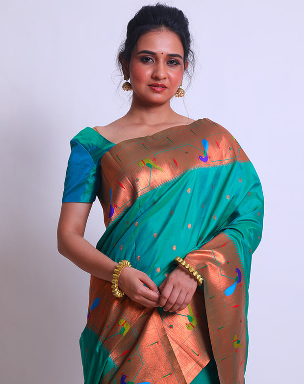 The peacock blue blended saree with Pathani parrot and raindrops zari design on the border and pallu sounds absolutely mesmerizing - BLN01289