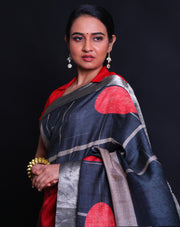 The black Desi Tussar saree featuring a zari border and pallu exudes timeless elegance.- PTS05292