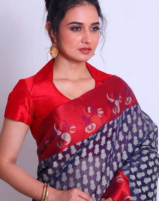A Navy Blue Cotton saree with a contrast rust border featuring flower design sounds lovely - FCT011141!