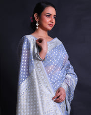 The light blue kora cotton saree adorned with zari and thread woven small buttis all over the drape,- BSK010448