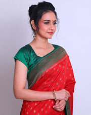 A Red Soft Silk saree with a contrast green border and pallu adorned with antique Zari - FCT011141